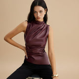 Yemelia sleeveless draped faux leather top in deep burgundy with a high neckline and fitted silhouette.
