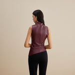 Yemelia sleeveless draped faux leather top in deep burgundy with a high neckline and asymmetric hem.
