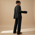 Yemelia charcoal grey knit lounge set with relaxed fit sweater and wide leg pants, ribbed cuffs and hem.