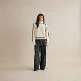 Yemelia cream knit turtleneck sweater with black contrast trim detailing on neckline, shoulders, sleeves, and hem. Relaxed fit.