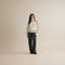 Yemelia cream knit sweater with black contrast trim, ribbed turtleneck, cuffs, and hem. Relaxed fit.
