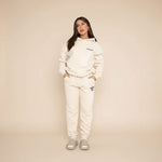 Yemelia cream relaxed fit hoodie and jogger set with graphic accent, made from soft fabric.