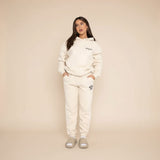 Yemelia cream relaxed fit hoodie and jogger set with graphic accent, made from soft fabric.