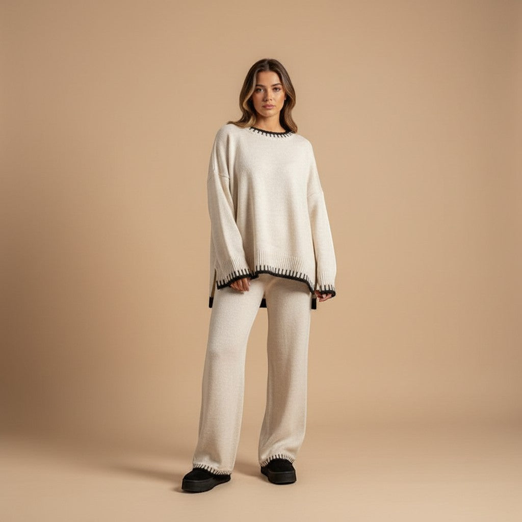 Yemelia cream knit lounge set with black contrast trim on crew neck, cuffs, and hem. Relaxed fit sweater and wide-leg pants.