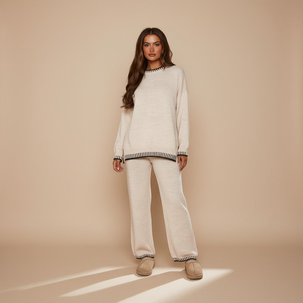 Yemelia cream knit lounge set with crewneck sweater and wide-leg pants featuring black contrast trim.