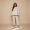 Yemelia cream knit lounge set with crewneck sweater and wide-leg pants featuring black contrast trim.