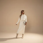 Yemelia cream knit turtleneck sweater and midi skirt set. Soft knit fabric, relaxed fit sweater, fitted skirt.