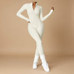 Yemelia cream long sleeve zip front sculpting one piece jumpsuit with full-length legs and high neckline.