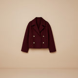 Yemelia cropped double-breasted tailored jacket in deep red with wide lapels and gold buttons.