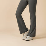 Yemelia dark grey sleeveless sculpting flared leg jumpsuit made of smooth stretch fabric.