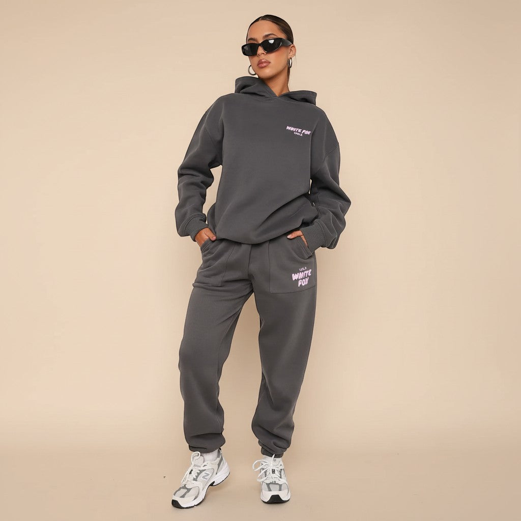 Yemelia dark grey relaxed fit cotton hoodie and jogger set with subtle pink graphic accent. Ideal for casual wear.