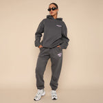 Yemelia dark grey relaxed fit cotton hoodie and jogger set with subtle pink graphic accent. Ideal for casual wear.