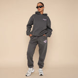 Yemelia dark grey relaxed fit cotton hoodie and jogger set with subtle pink graphic accent. Ideal for casual wear.