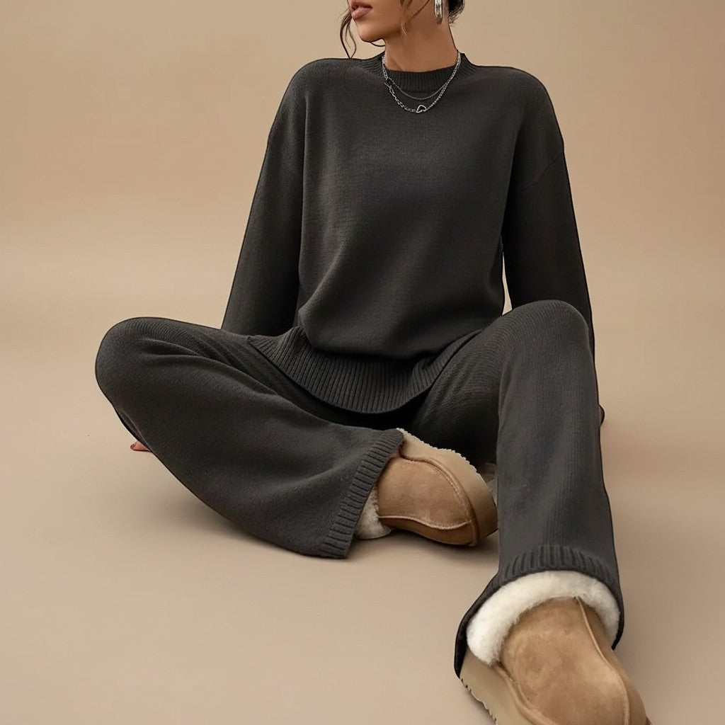Yemelia dark grey knit lounge set with relaxed fit sweater and wide leg pants, featuring ribbed cuffs and hem.
