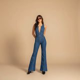 Yemelia deep V neck blue denim jumpsuit with flared legs and front zip closure.