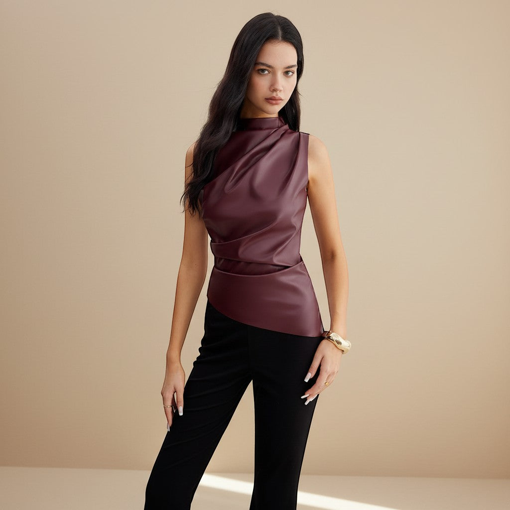 Yemelia sleeveless draped faux leather top in deep burgundy with a high neckline and asymmetrical hem.