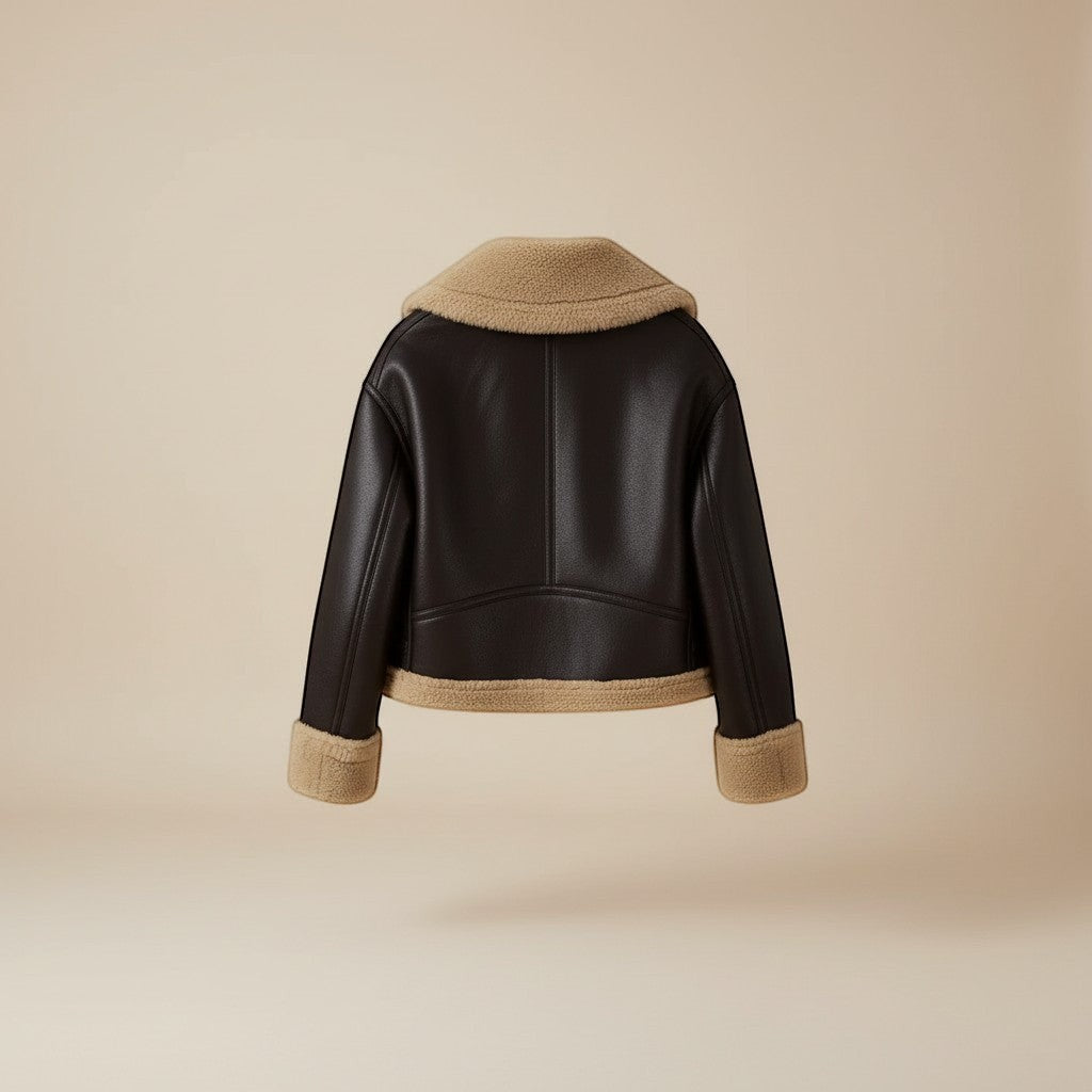 Yemelia dark brown faux leather jacket with tan shearling trim on collar, cuffs, and hem. Zip front.
