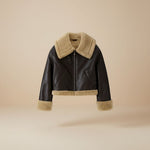 Yemelia dark brown faux leather jacket with cream shearling trim on collar, cuffs, and hem. Zip front closure.