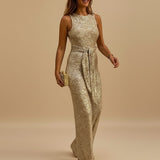 Yemelia gold sequin sleeveless wide leg jumpsuit with waist tie, perfect for evening events.