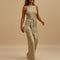 Yemelia gold sequin sleeveless wide leg jumpsuit with waist tie, perfect for evening events.