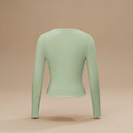 Yemelia light green long sleeve fitted crop top with thumbhole cuffs and a clean neckline, made from soft stretchy fabric.