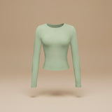 Yemelia light green long sleeve fitted crop top made from soft, stretchy fabric with thumbhole cuffs.