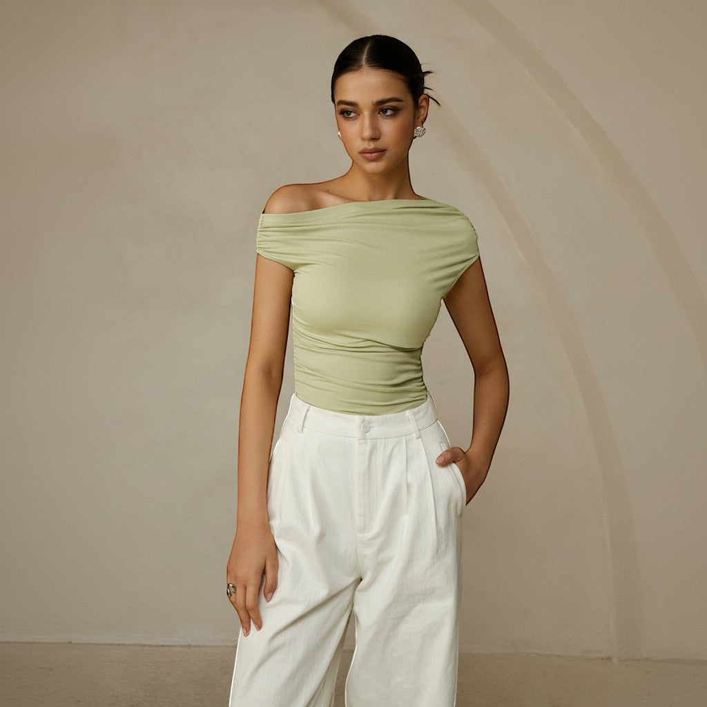 Yemelia light green ruched one-shoulder fitted top with asymmetrical neckline and stretch fabric.
