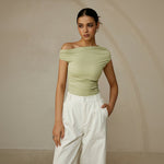 Yemelia light green ruched one-shoulder fitted top with asymmetrical neckline and stretch fabric.