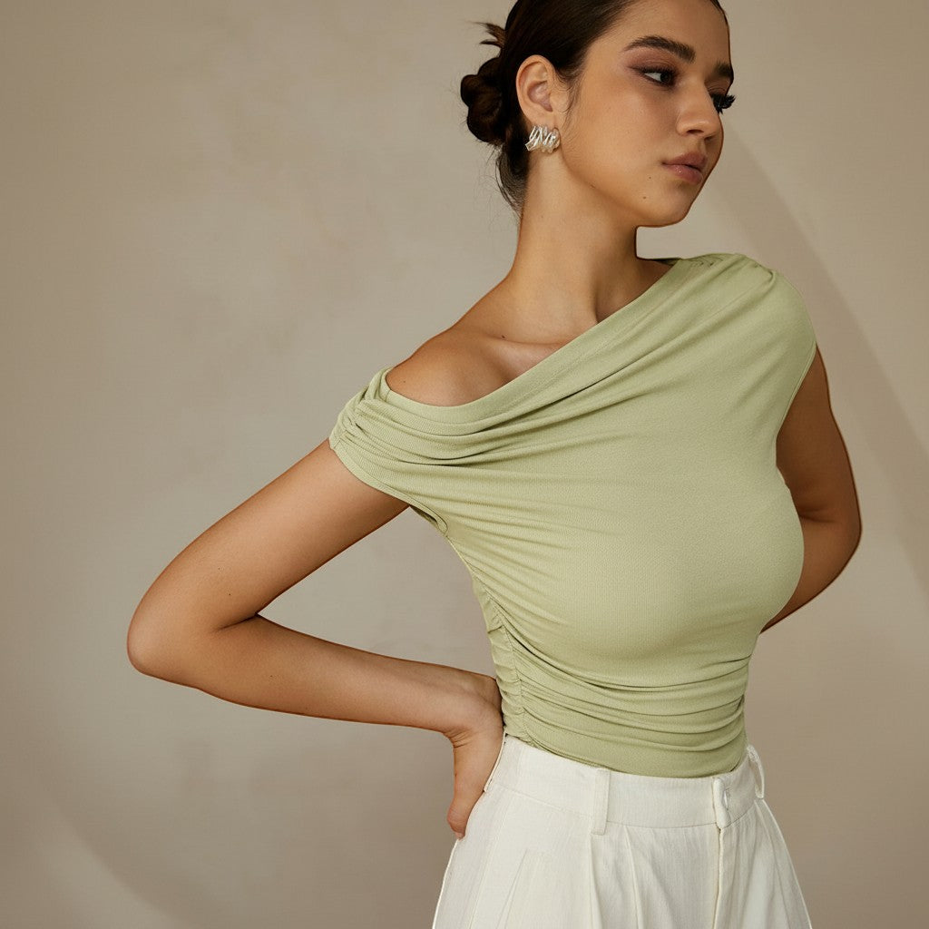 Yemelia light green ruched one-shoulder top with asymmetrical neckline and stretch fabric.