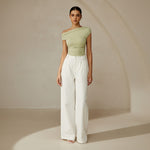 Yemelia light green ruched one-shoulder top with asymmetrical neckline and stretch fabric.