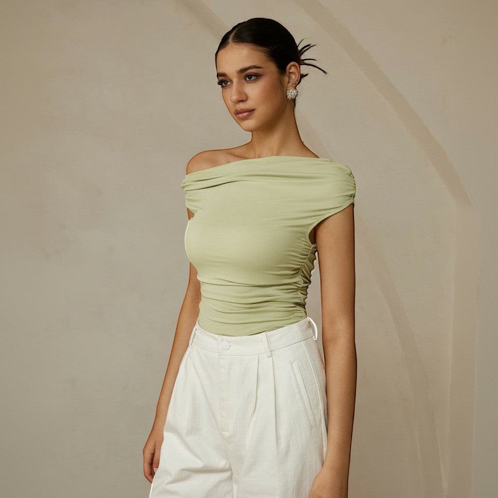Yemelia light green ruched one-shoulder top with asymmetrical neckline, made of stretch fabric.