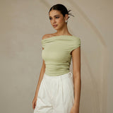 Yemelia light green ruched one-shoulder top with asymmetrical neckline, made of stretch fabric.