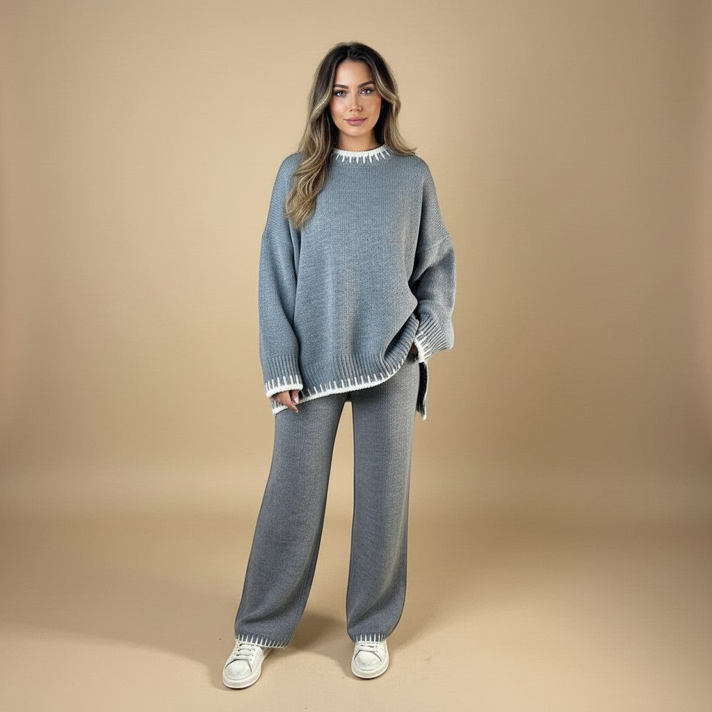 Yemelia grey knit lounge set with crewneck sweater and wide-leg pants, featuring contrast white trim detail. Soft knit fabric.