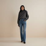 Yemelia grey knit turtleneck sweater with black contrast trim detailing on shoulders and sleeves. Relaxed fit.