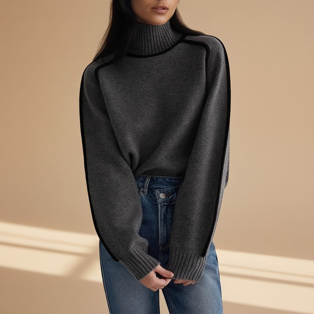 Yemelia grey knit turtleneck sweater with black contrast trim detailing on shoulders and sleeves, ribbed cuffs and hem.