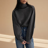 Yemelia grey knit turtleneck sweater with black contrast trim detailing on shoulders and sleeves, ribbed cuffs and hem.