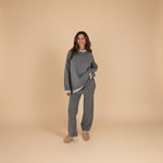 Yemelia grey knit lounge set with crew neck sweater and wide-leg pants, featuring contrast white trim.