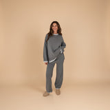 Yemelia grey knit lounge set with crew neck sweater and wide-leg pants, featuring contrast white trim.