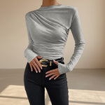 Yemelia grey long sleeve fitted top with asymmetrical ruching and mock neck. Stretch fabric.
