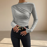 Yemelia grey long sleeve fitted top with asymmetrical ruching and mock neck. Stretch fabric.