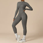Yemelia grey long sleeve zip front sculpting one piece jumpsuit made of stretch fabric for a sleek, contoured silhouette.