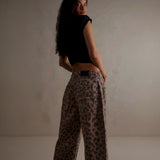 Yemelia brown and black leopard print wide leg denim jeans with mid-rise waist and five-pocket styling.