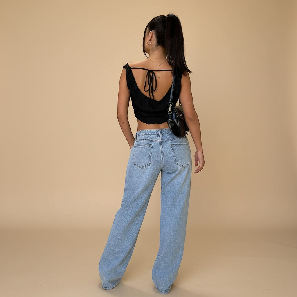 Yemelia light wash denim jeans with a relaxed fit and wide leg. Features a low rise waist and classic five-pocket design.