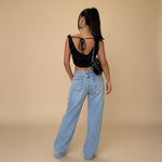 Yemelia light wash denim jeans with a relaxed fit and wide leg. Features a low rise waist and classic five-pocket design.