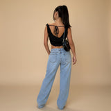 Yemelia light wash denim jeans with a relaxed fit and wide leg. Features a low rise waist and classic five-pocket design.