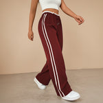 Yemelia high waist wide leg track pants in maroon with white side stripes and elasticated drawstring waist.