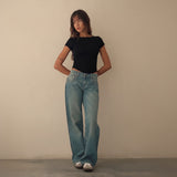 Yemelia mid rise wide leg denim jeans in a light blue wash with a relaxed fit and five-pocket design.