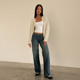 Yemelia mid rise wide leg denim jeans in a faded blue wash with a relaxed fit and five-pocket design.