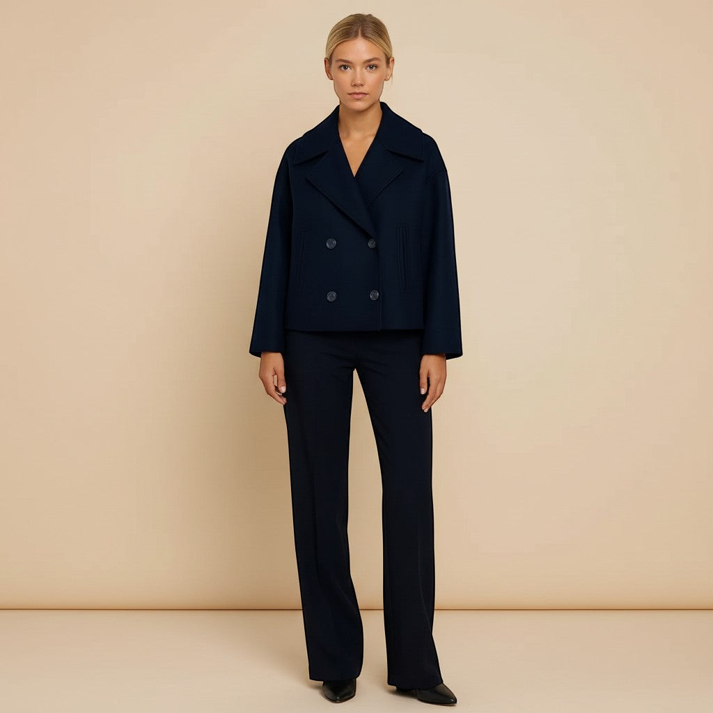 Yemelia navy blue cropped double-breasted jacket with wide lapels and decorative buttons.