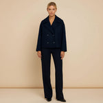 Yemelia navy blue cropped double-breasted jacket with wide lapels and decorative buttons.